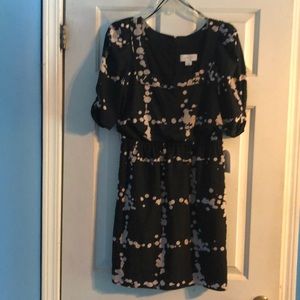 Black dress with beige spots.